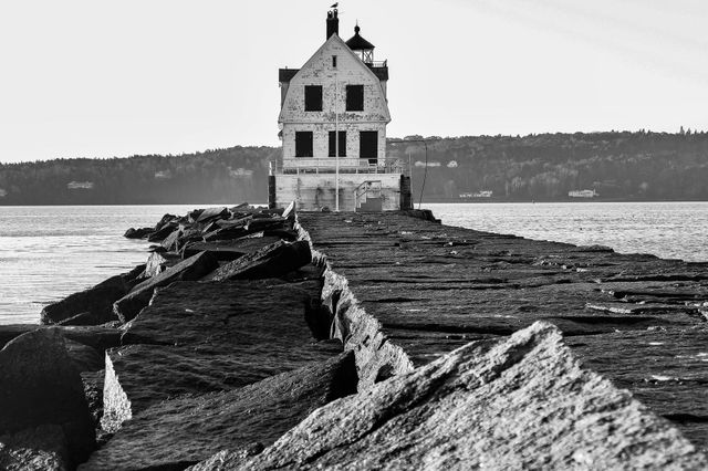 “Breakwater Light”. A seagull patrols Rockland Harbor from the  chimney of the light keeper’s house at the end of the Rockland Breakwater in Midcoast Maine.