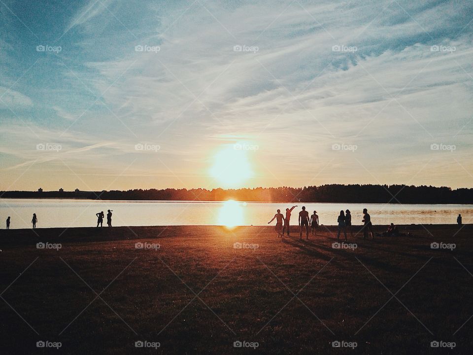 Summer sports . People playing sports at sunset 