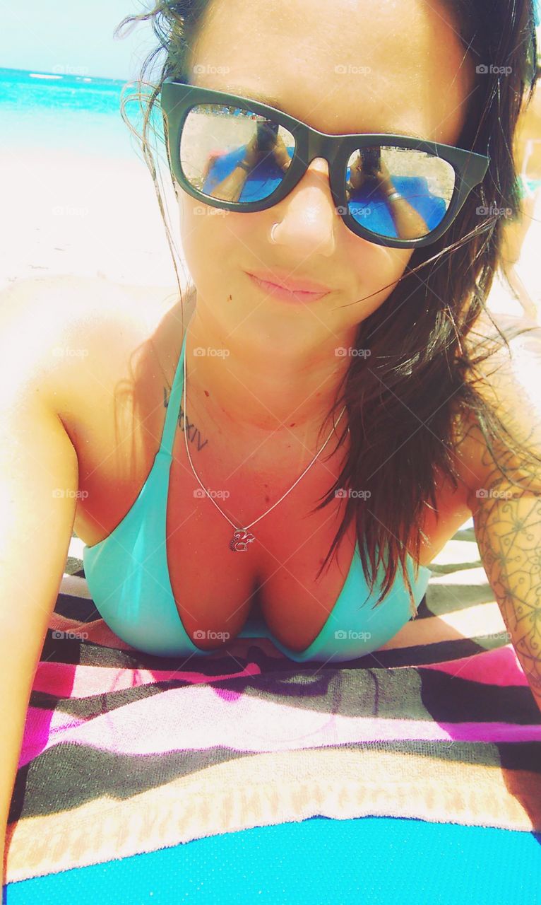 Close-up of a woman wearing sunglasses at beach