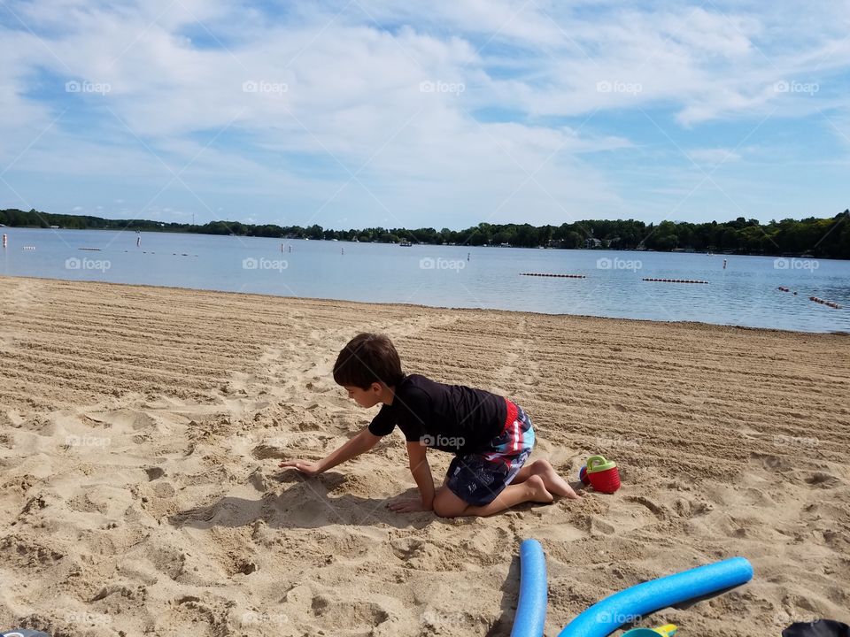 Boy playing at beach