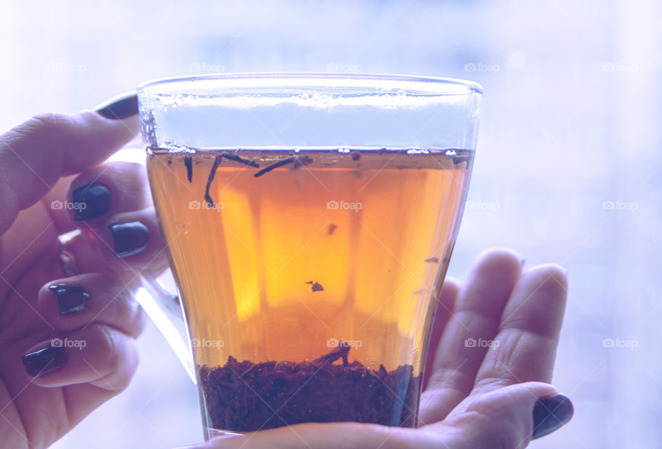 A woman holding a cup of tea