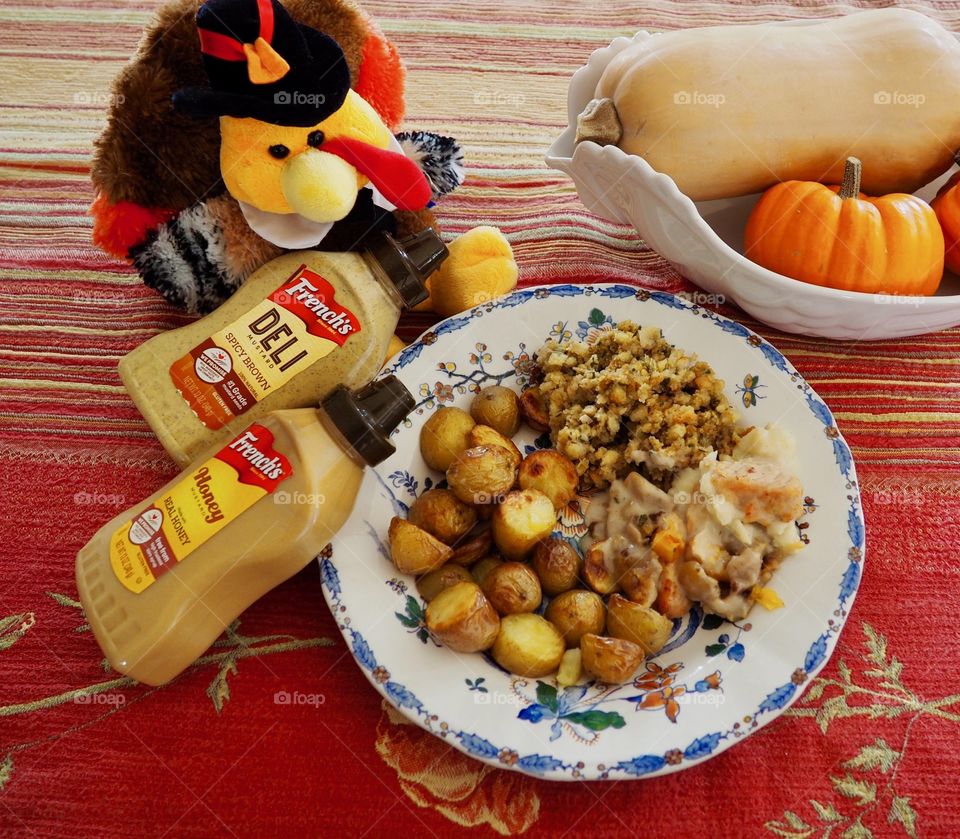 Thanksgiving plate of turkey in a creamy French’s deli and honey mustard sauce with stuffing and roasted potatoes.