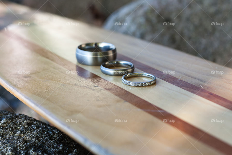 Bride and groom's wedding rings on a canoe paddle 