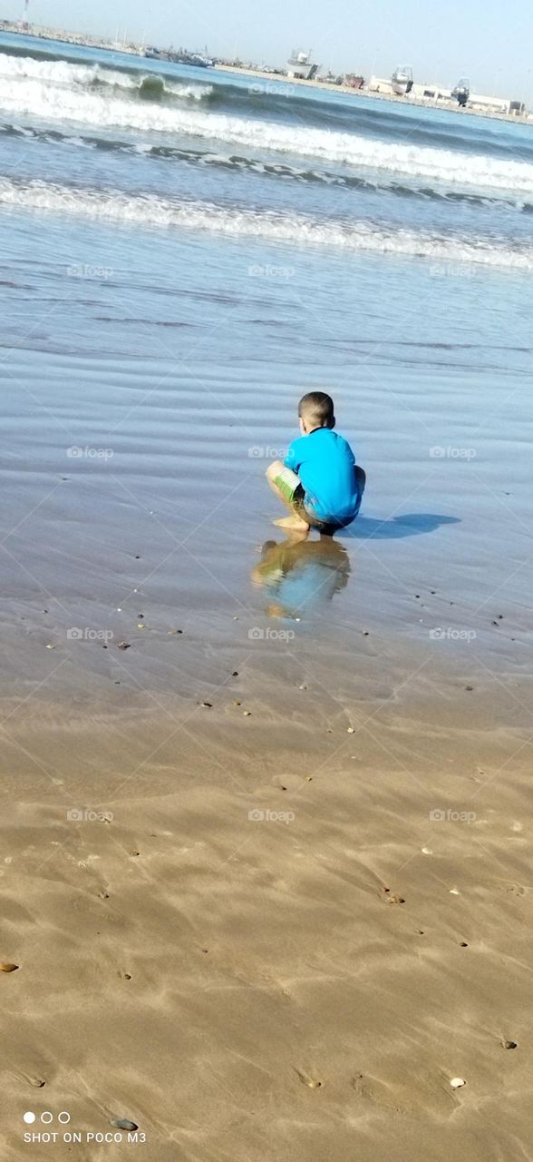 a young boy near the sea.