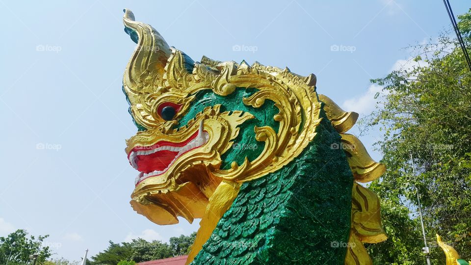 ancient serpent head statue in thailand.