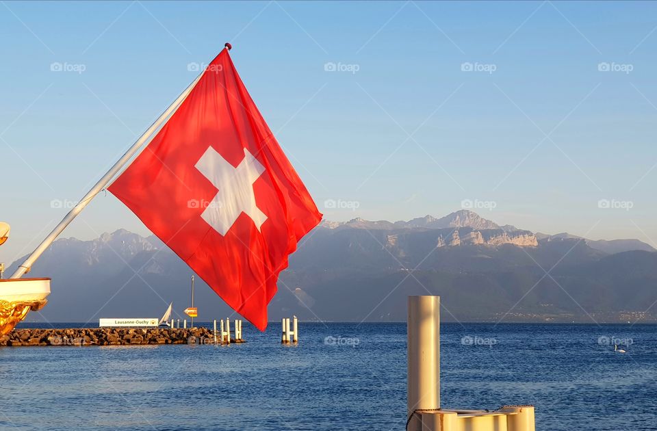 Swiss flag over lake