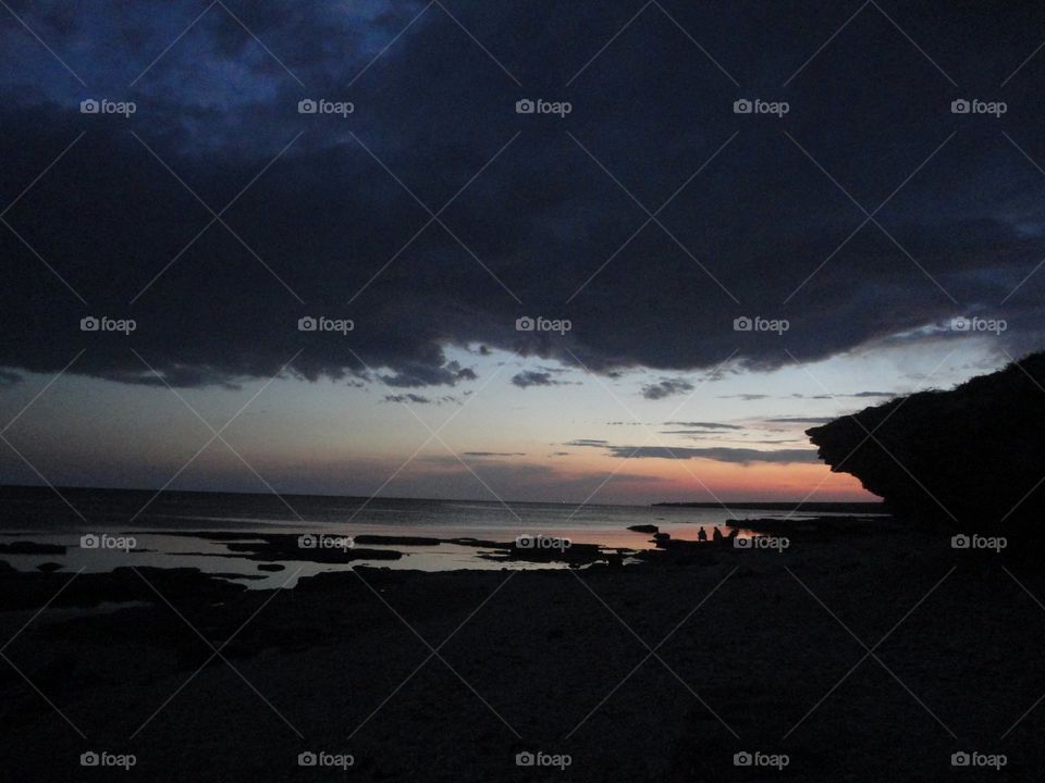 people resting on a evening sunset sea shore summer travel