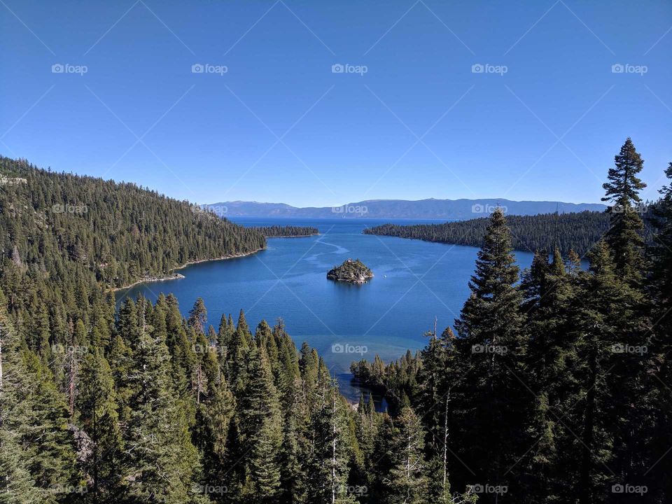 Emerald Bay at Lake Tahoe in California - Beautiful Blue Water (Bay and Lake) Surrounded by Green Trees and Forest on a Sunny Day