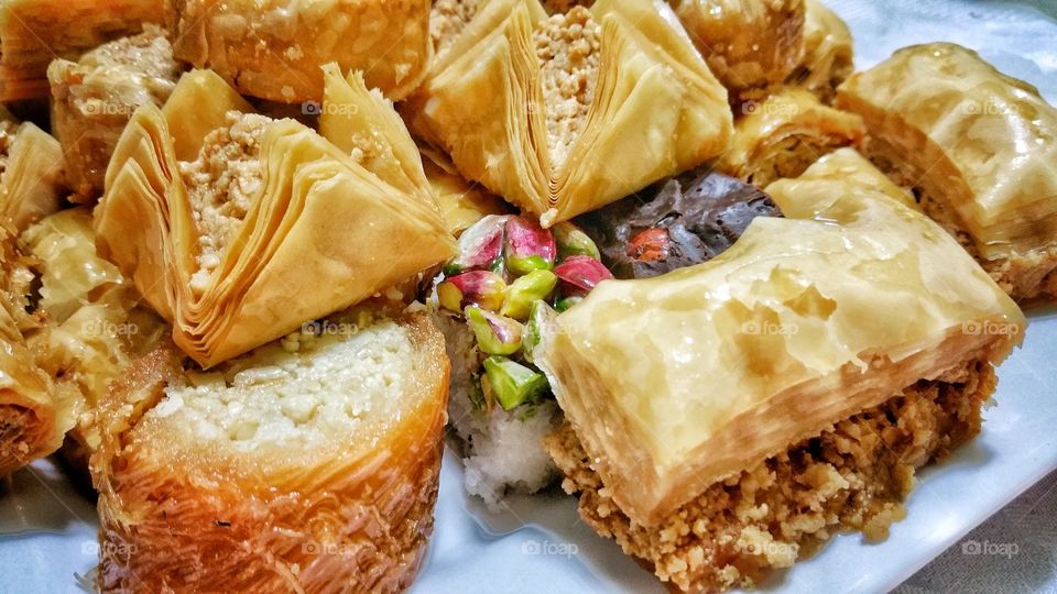 Baklava - different varieties in closeup. A rich, sweet pastry made of layers of filo filled with chopped nuts and sweetened and held together with syrup or honey.  Popular around the Mediterranean, Central and West Asia.
