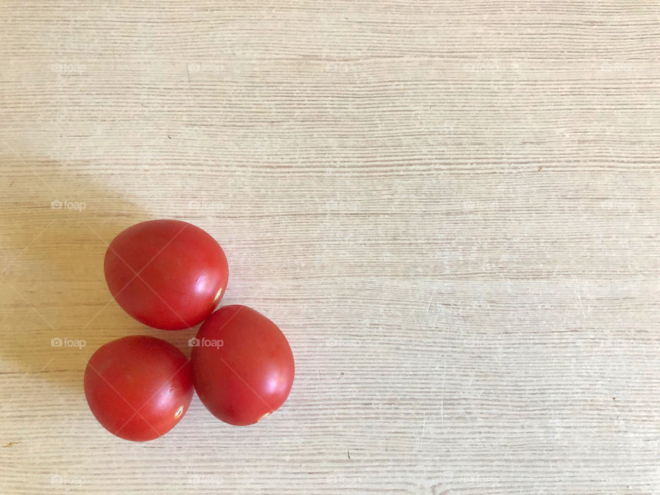red tomatoes on wooden background