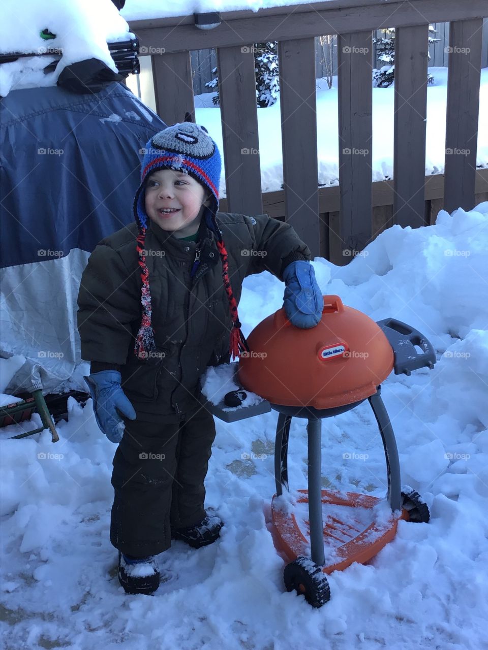 Toddler playing outside in the snow