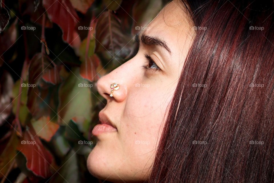 Beautiful girl with golden jewellery in her pierced nostril