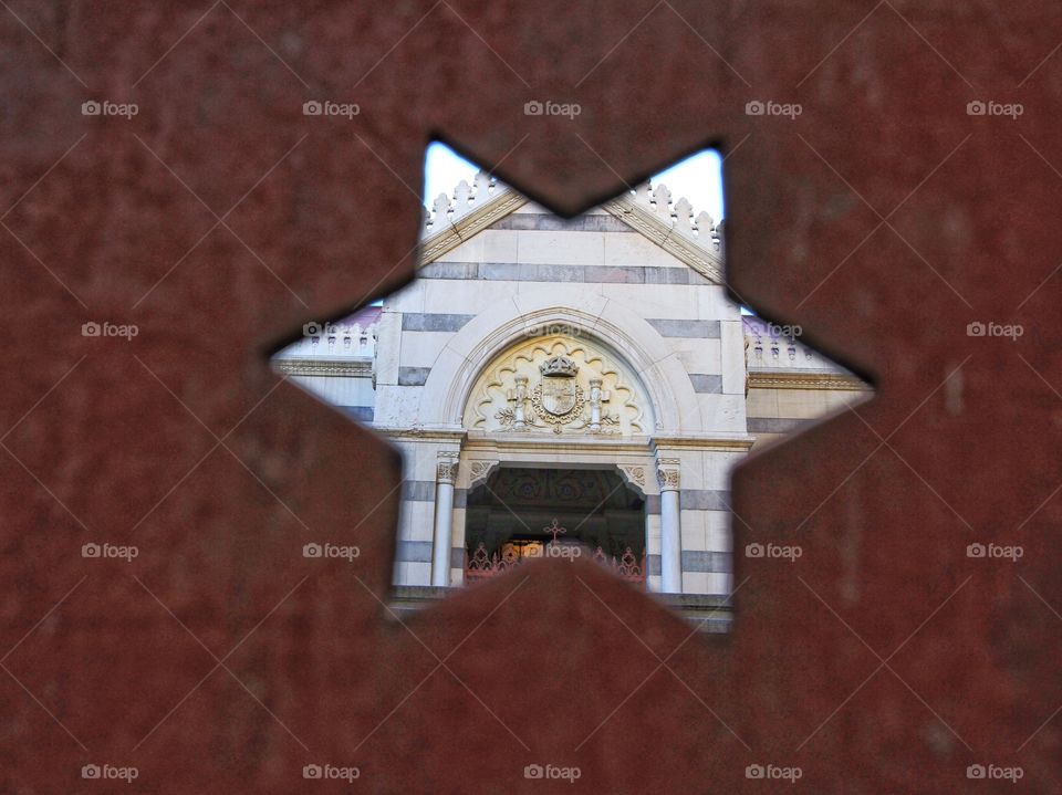View of church through star in gate 