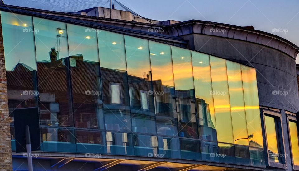 Greenwich reflecting in modern glass building 