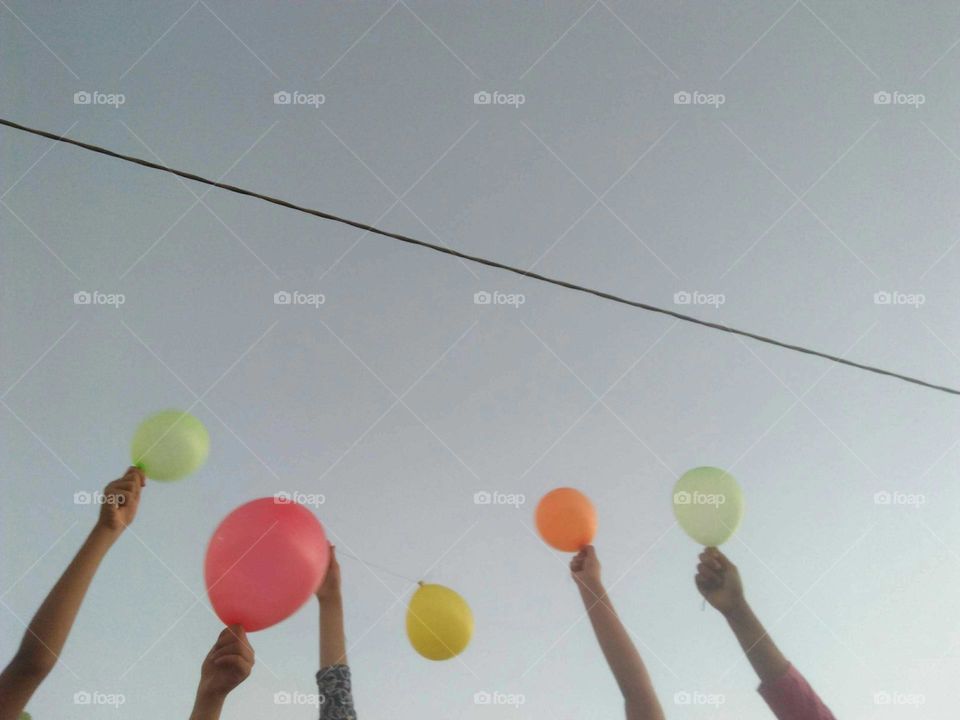 Balloons and hands.