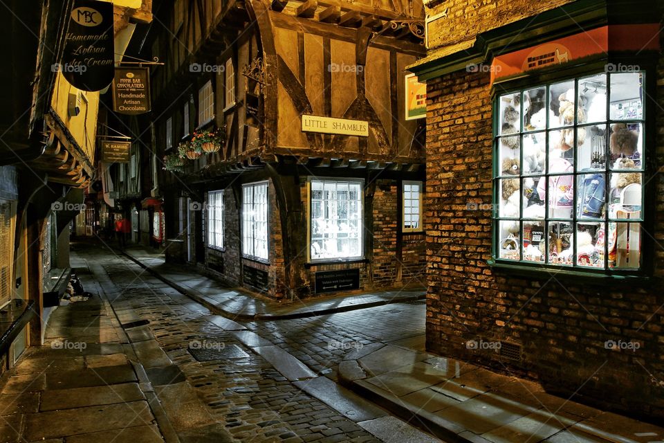 The Shambles medieval street in York, UK is a historic tourist destination and is shown here at night.