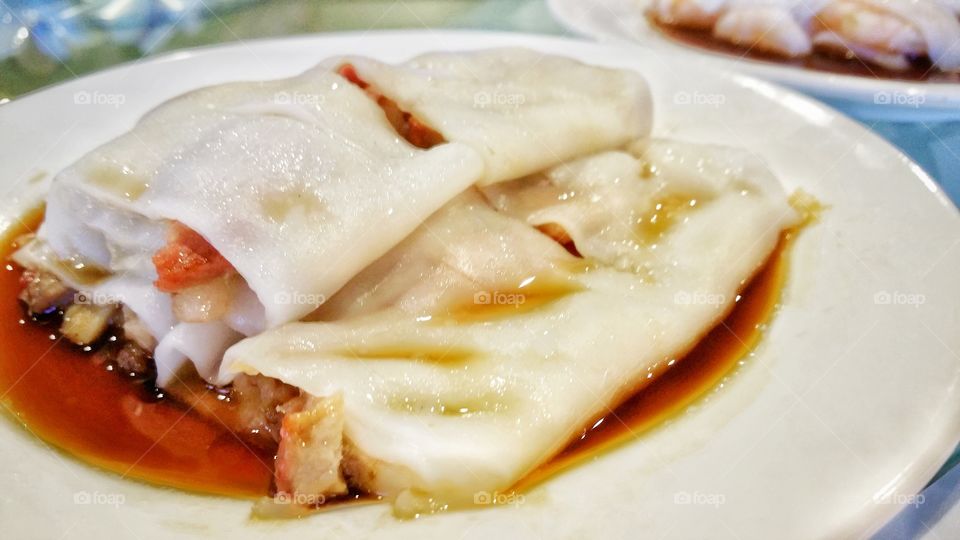 Chinese yum cha roast pork rice noodle. This is a typical Cantonese dim sum dish from Southern China, including Hong Kong. Served as a snack or small meal.