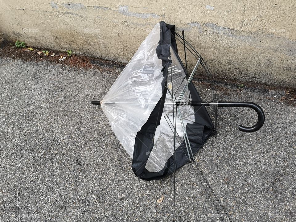 Umbrella broken on the street after a storm