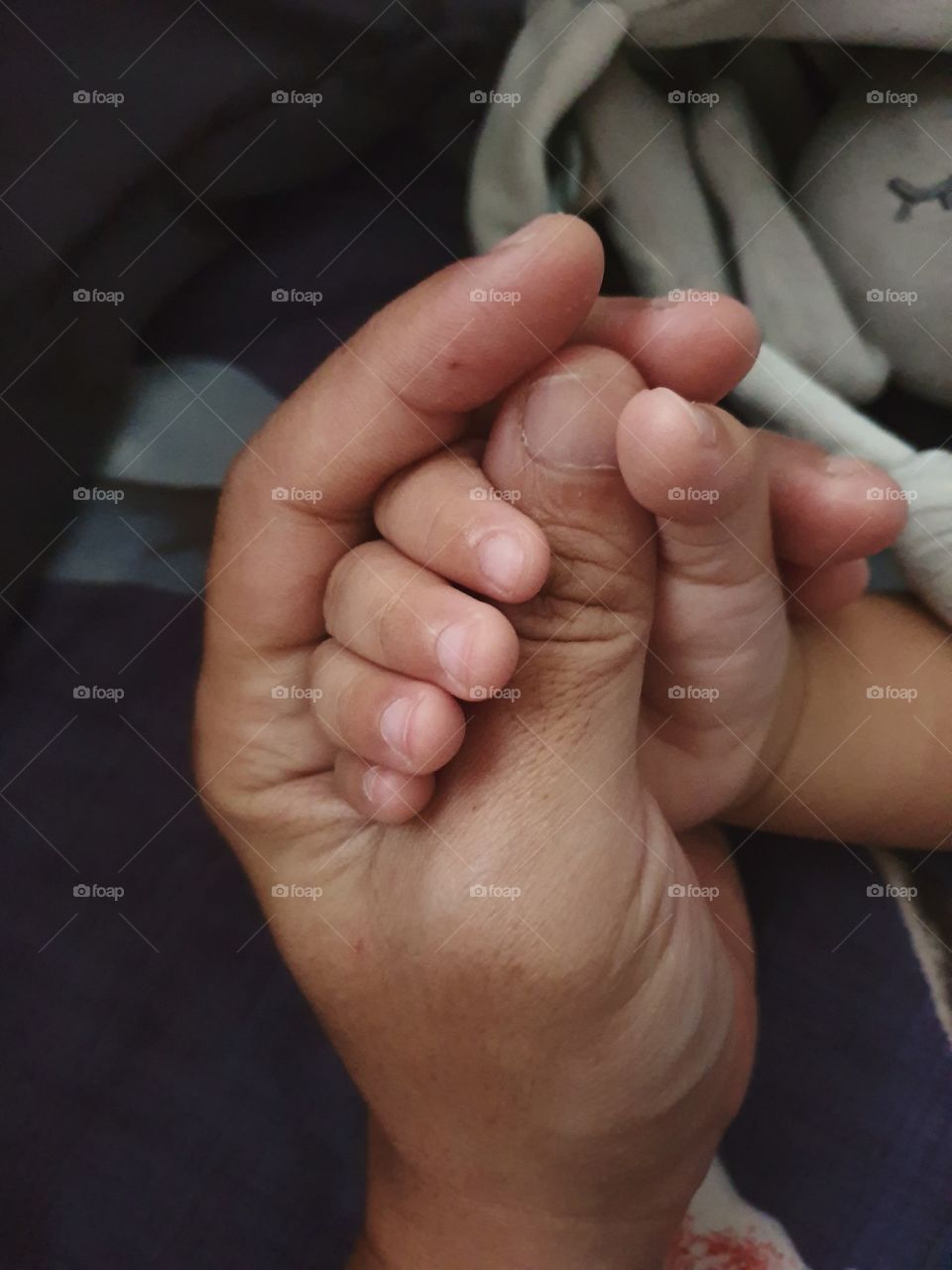 toodler holding hand while sleeping