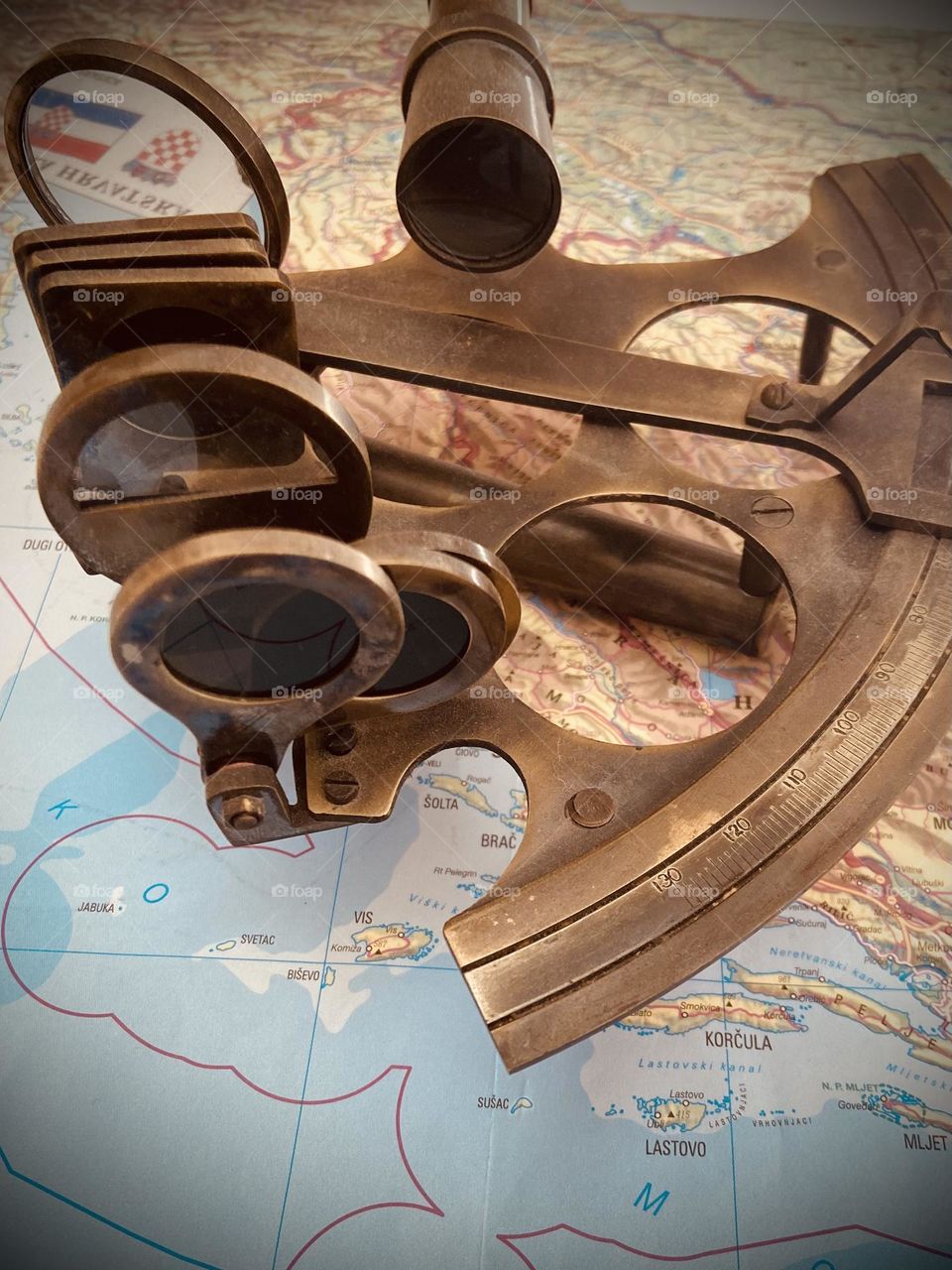 A sextant and map of the Adriatic Sea reliving the age of discovery and adventure at sea.