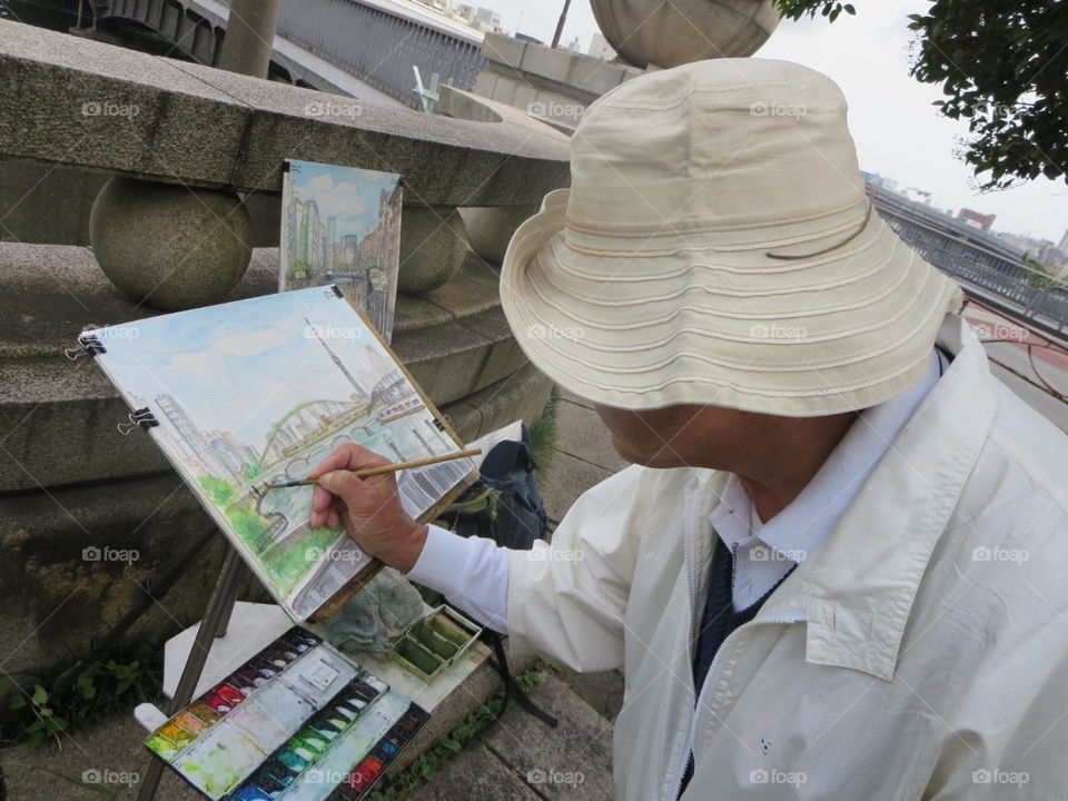 The japanese Oldman Celebrating holiday by Drawing the picture of view what he sees...At SumidaGaawa in Japan...