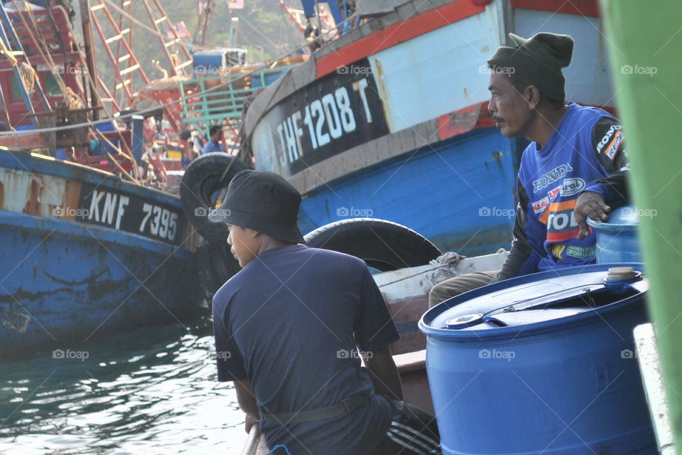 two generations. a fisherman and his son