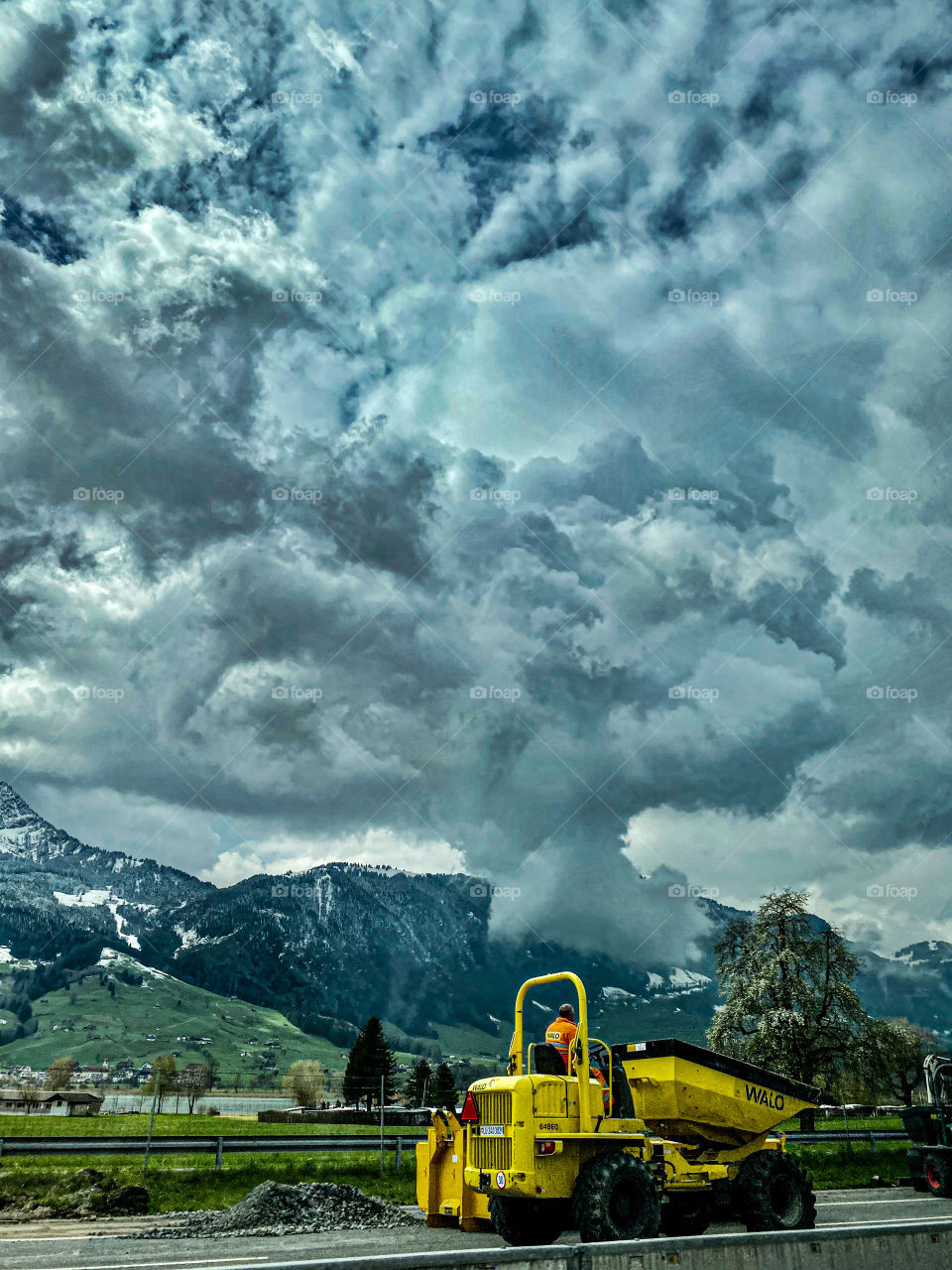 Swiss beauties, Swiss mountains, clouds floating over the Alps, railway, stop, bus, beautiful painted building, road