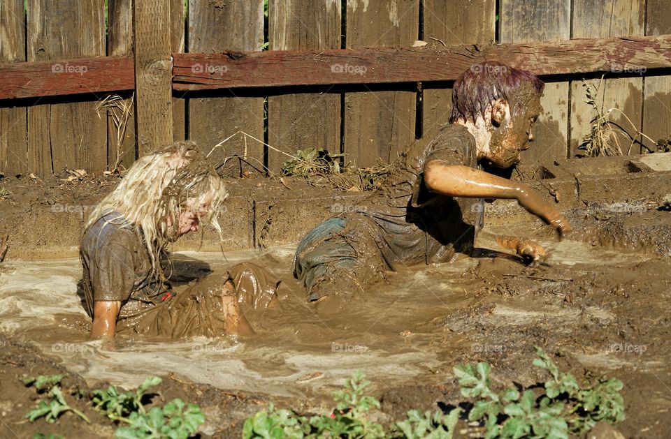 Kids Playing In The Mud