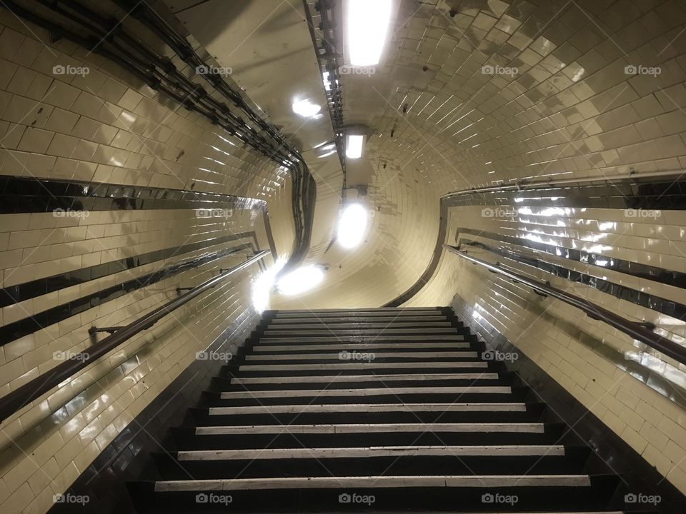 Stairs up from platform level to the emergency stairs at Archway Underground Station, London. Photographed on a Summer evening en route to catching the Northern Line home.