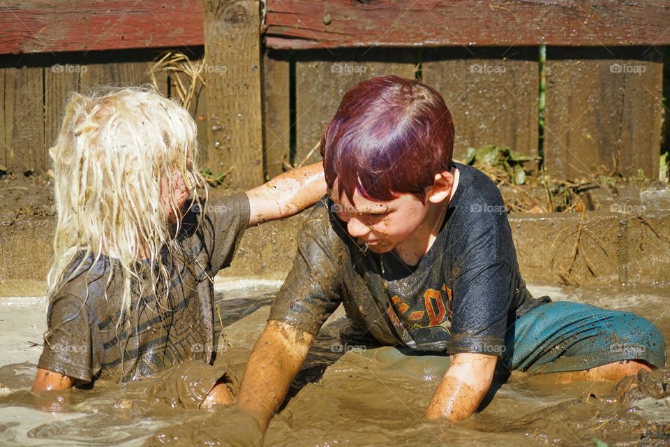 Kids Playing In Mud