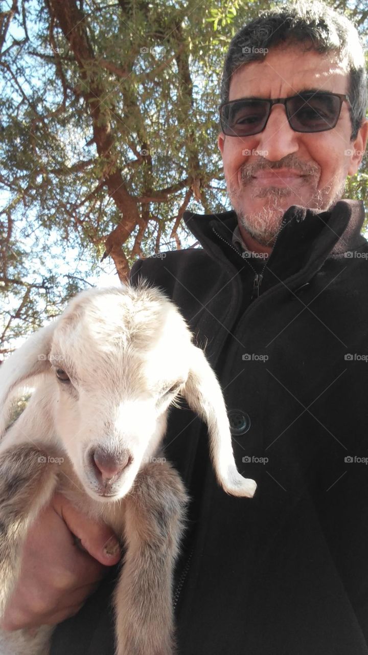 Im holding a gentle lamb.