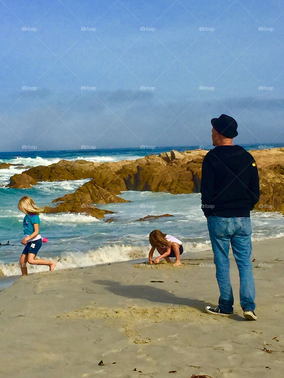 Papa and granddaughters at the beach in California. 
