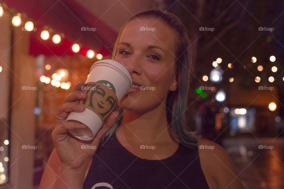 late evening Starbucks coffee run enjoying the taste as we walk down the street of shops and lights
