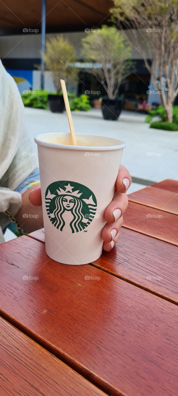 Holding cup of coffee from starbucks