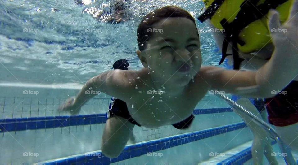 little guy holding breath underwater