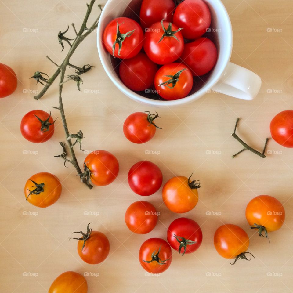 Fresh organic cherry tomatoes on table