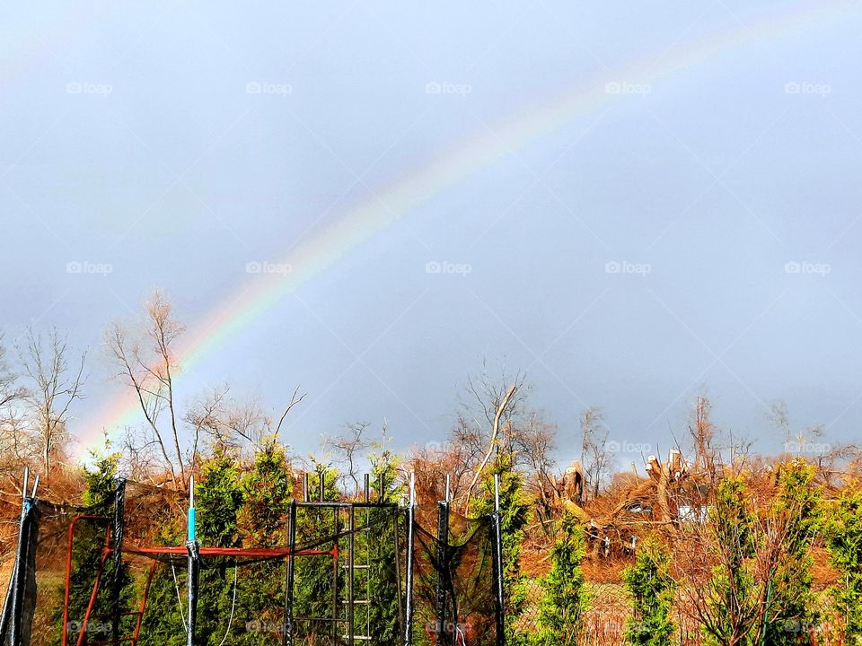 sunshine after spring rain with a rainbow