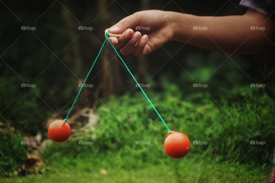 Human hands are playing a traditional game.