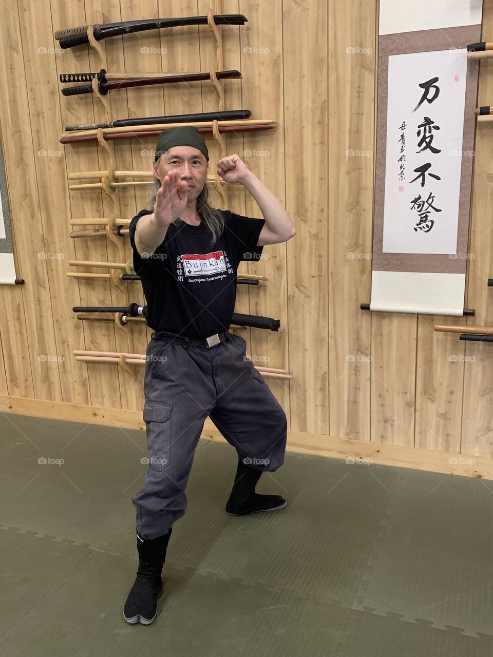 Ready to strike out from the combat posture at a martial arts dojo.