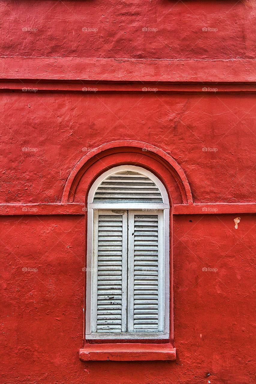 Window on red wall