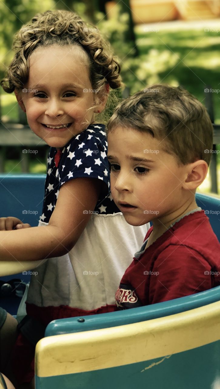 Smiling cute siblings playing in garden