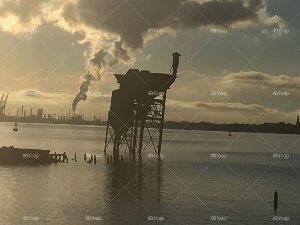 Silhouette of abandoned industry in bay