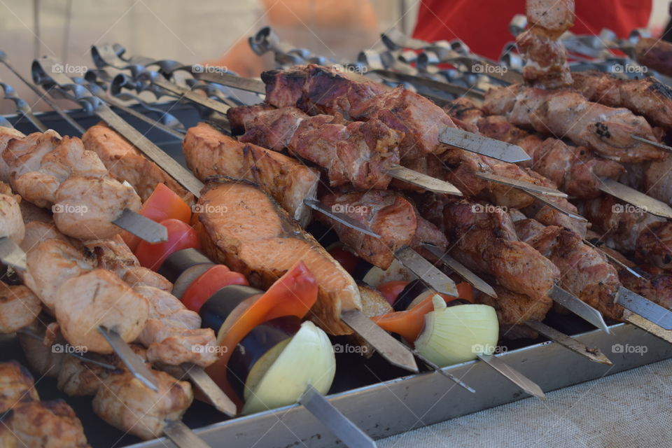 Meat and vegetables on skewers offered for sale at a street food festival