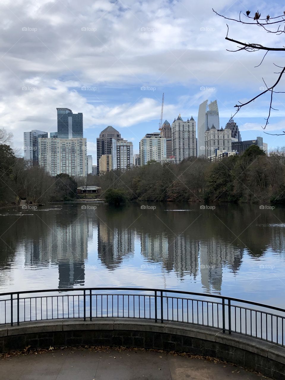 The downtown Atlanta skyline reflected in Piedmont Park’s lake- winter shot from the gazebo area.