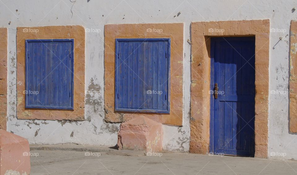 Old house with blue framed windows and doorway in 
Essouira,, Morocco, North Africa