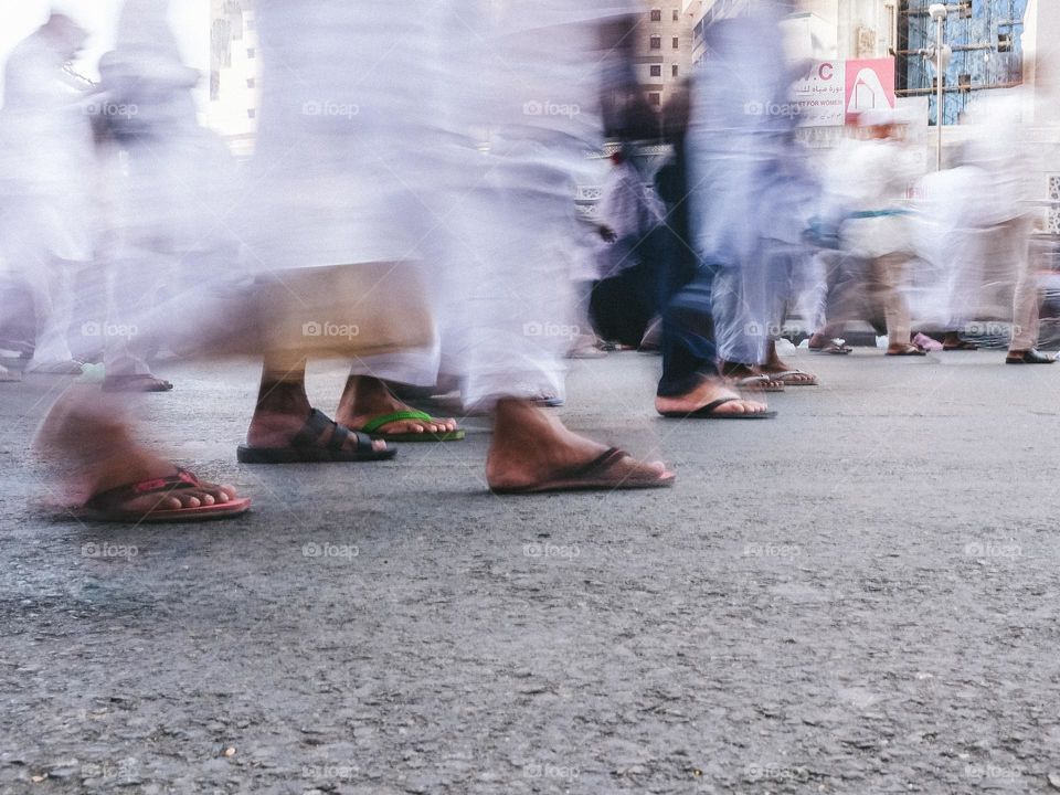 Slow shutter low angle view of haj pilgrims walking  in Mecca