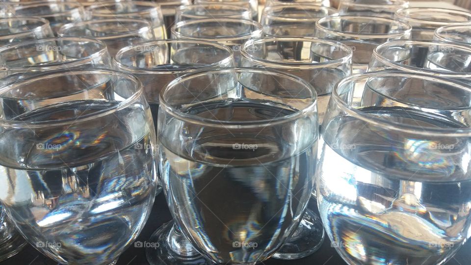a series of glasses containing water on the table atmospheric cafe location