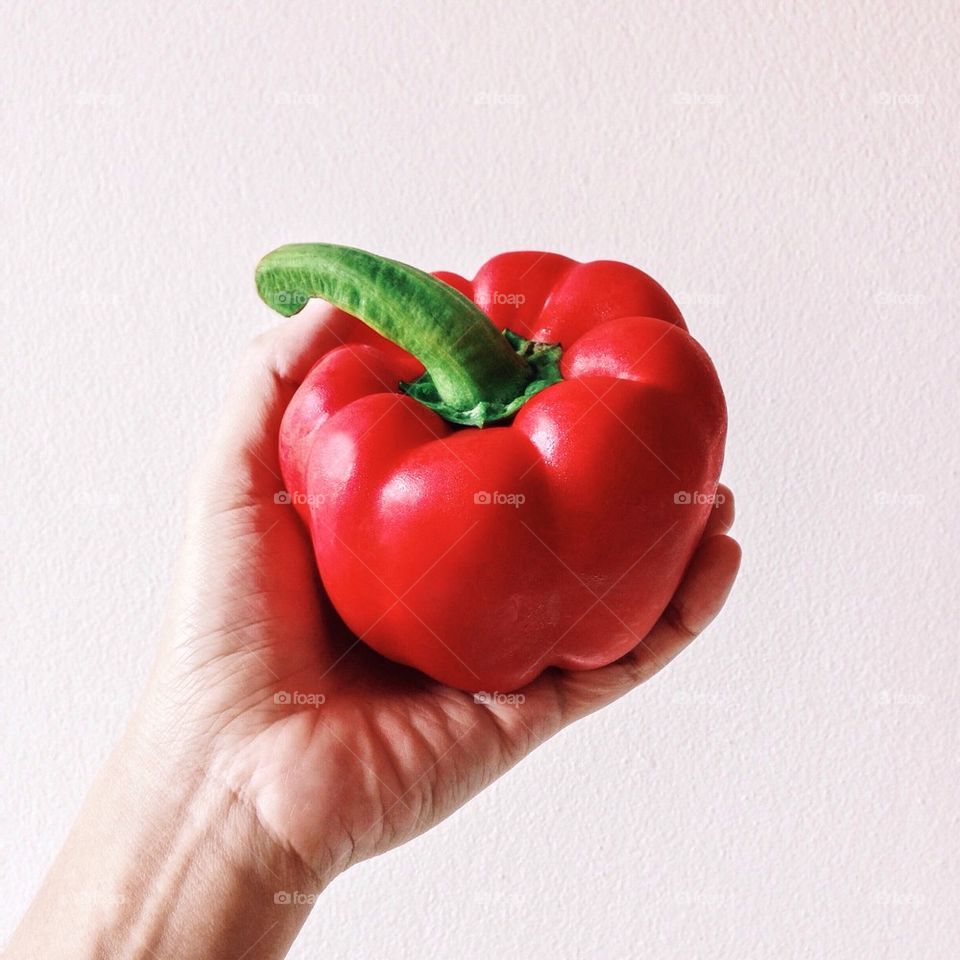 Red bell pepper in hand