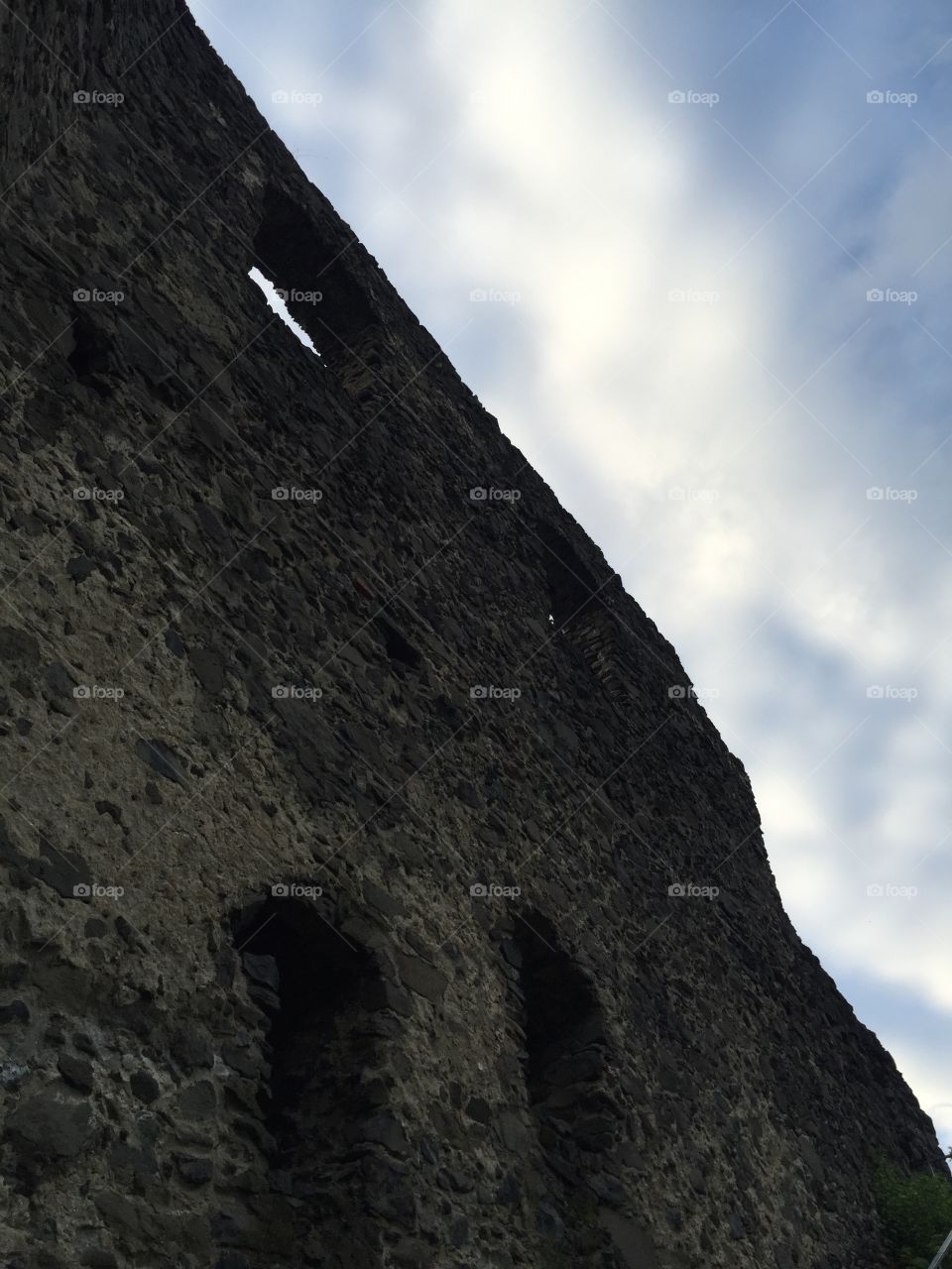 A wall of ruins of Nevytsky castle against the sky