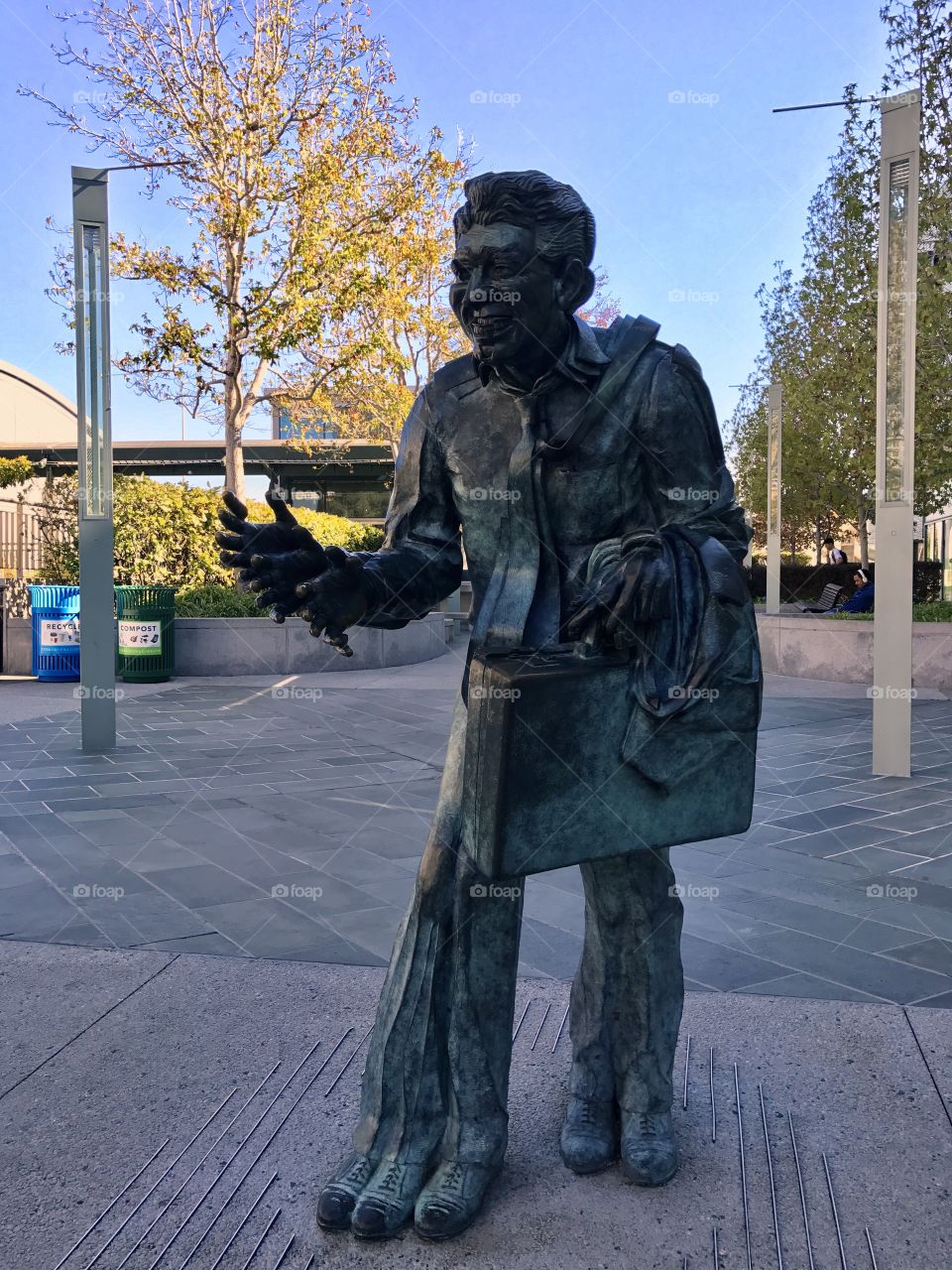 Statue of an old businessman coming apart.
